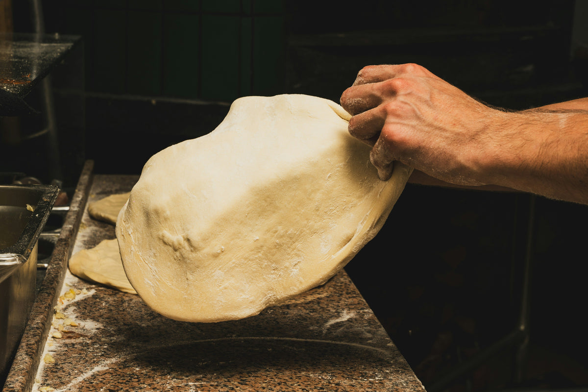 How to Stretch Pizza Dough Without Crying, Swearing or Pulling A Muscle